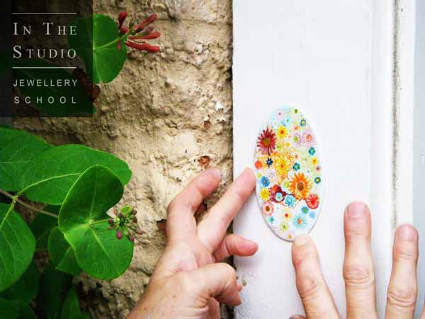 Student-displaying-enamel-pendant